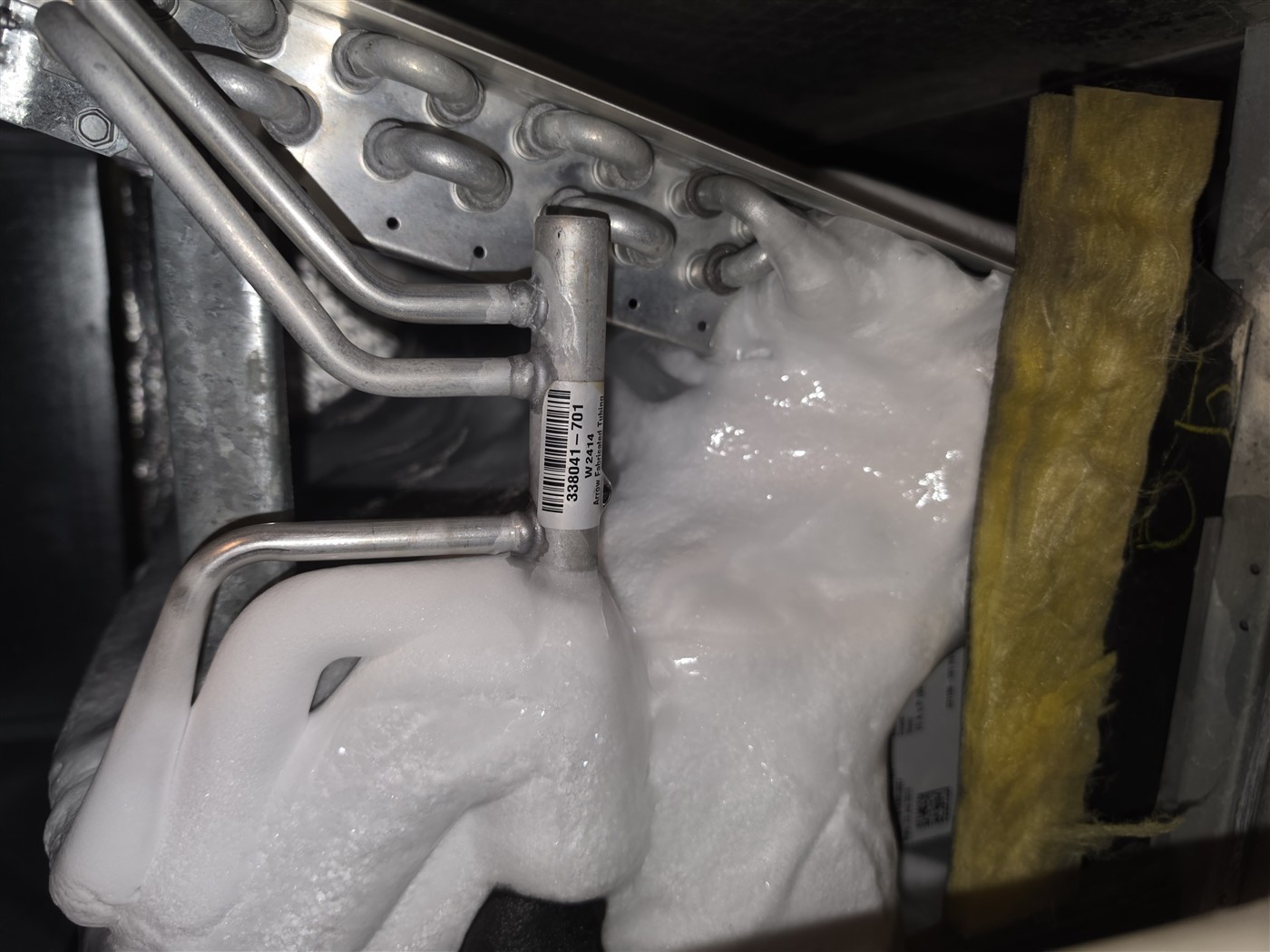 Ice built up across an evaporator coil from low airflow or low refrigerant